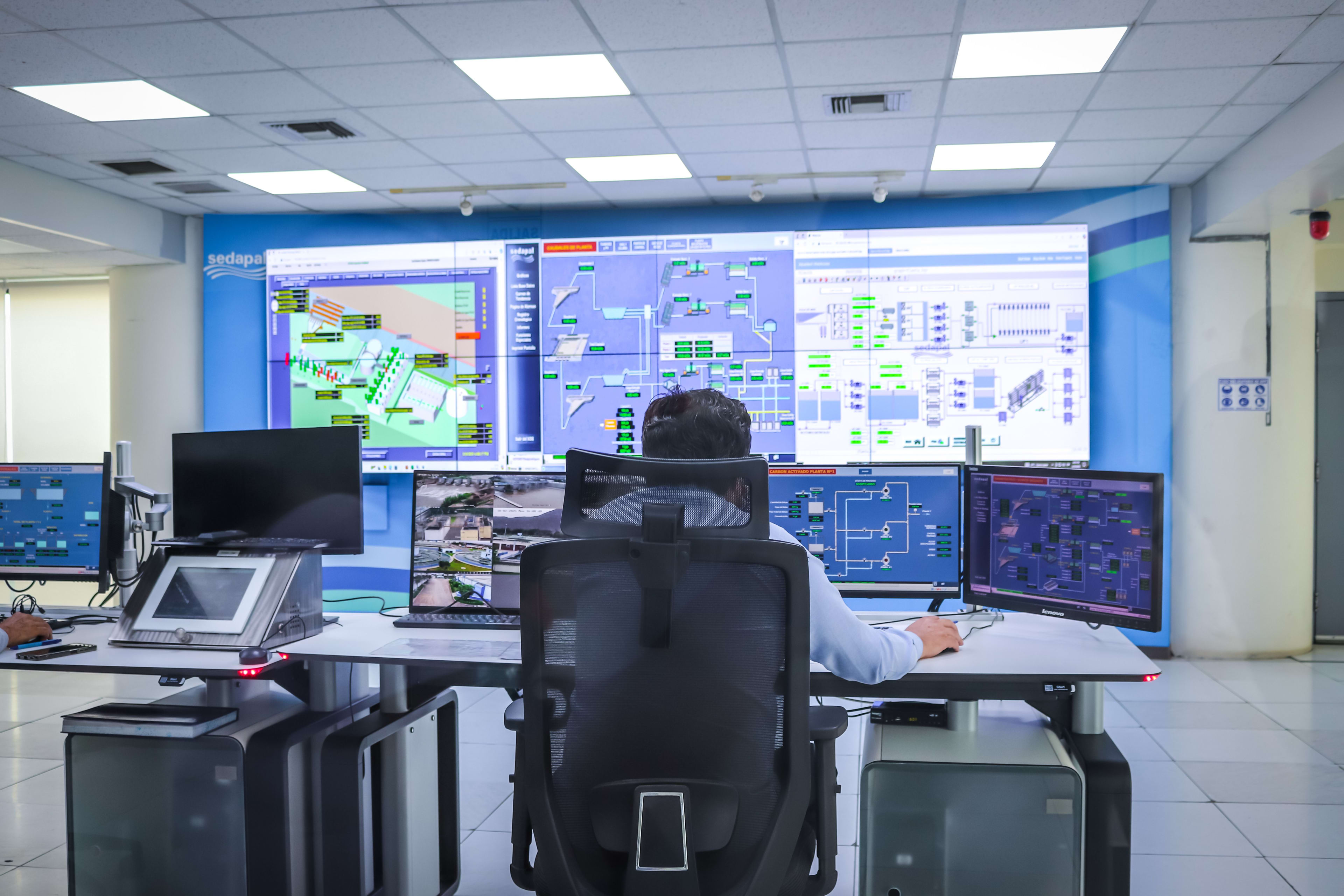 Software engineering team reviewing code on a screen